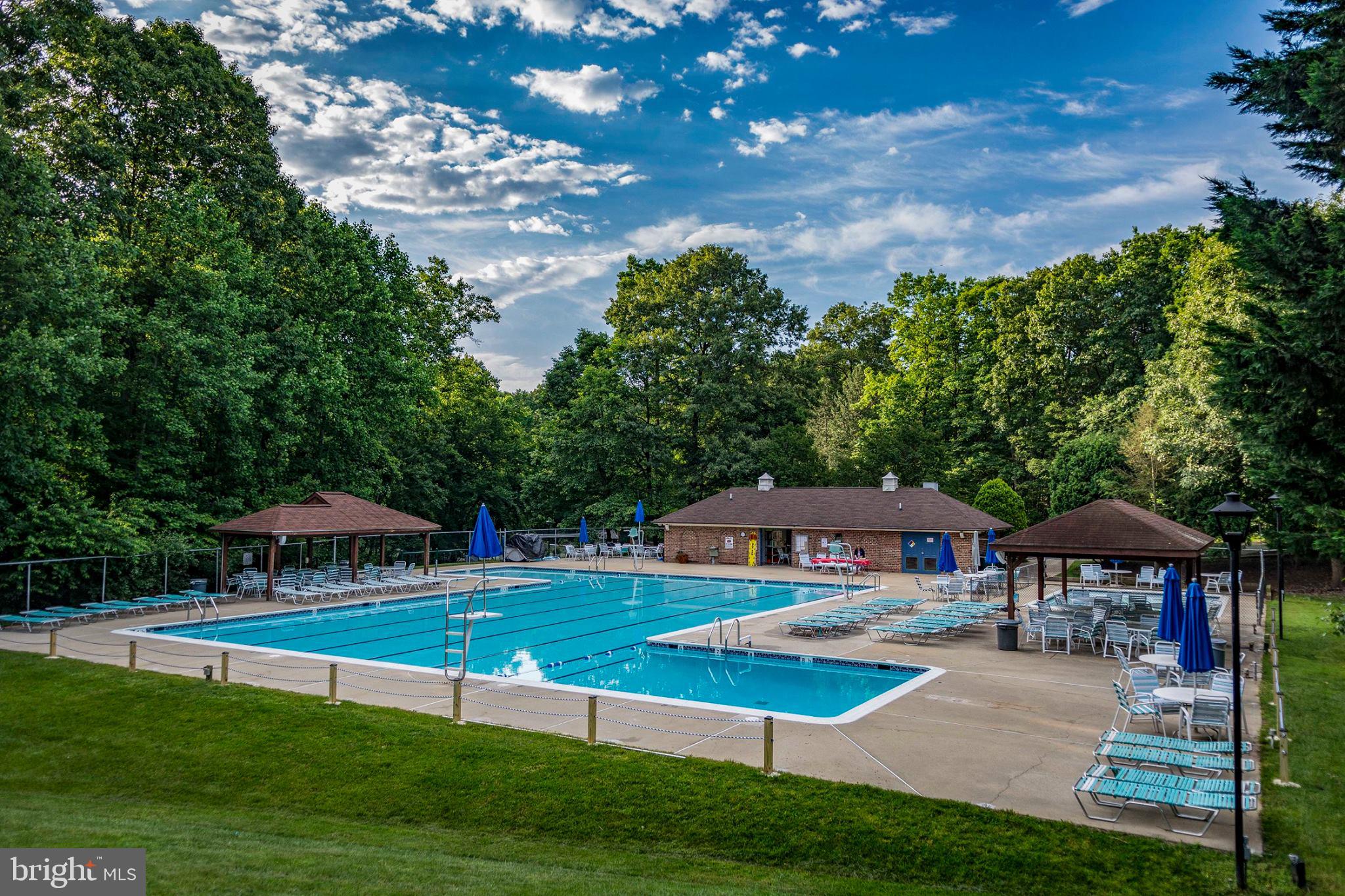 10655 John Ayres Drive Fairfax, VA 22032 - Photo 55 of 57 a view of pool with lawn chairs under an umbrella