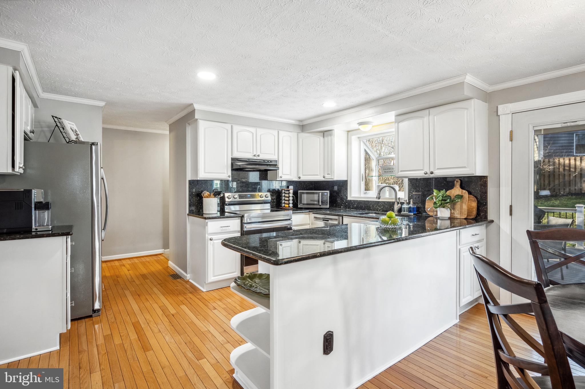 10655 John Ayres Drive Fairfax, VA 22032 - Photo 9 of 57 a kitchen with stainless steel appliances granite countertop a stove refrigerator sink and cabinets