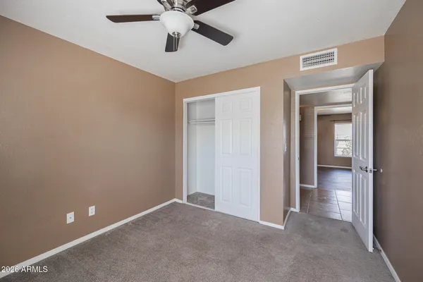a view of an empty room and closet area