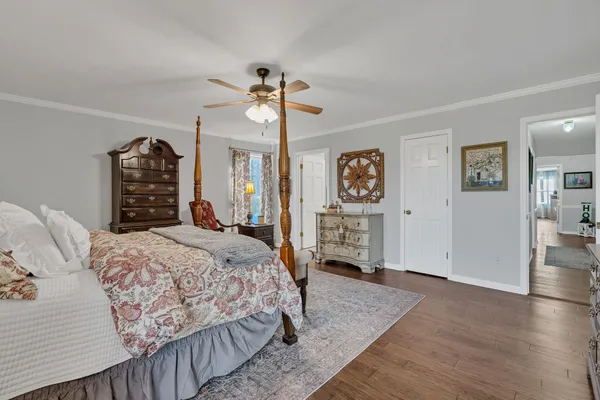 a bedroom with a bed a couch and dresser