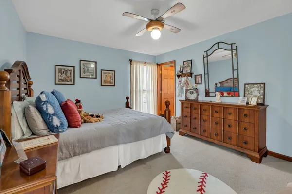 a bedroom with furniture and a large window