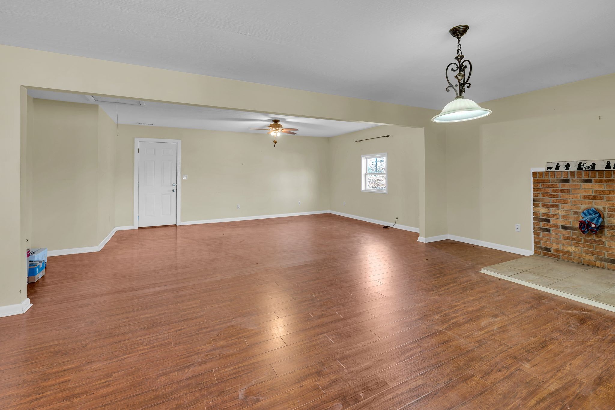729 Rabbit Trail Road Leoma, TN 38468 - Photo 40 of 52 an empty room with wooden floor chandelier and windows