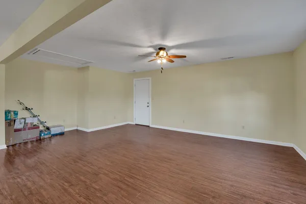 a living room with kitchen island furniture and a wooden floor
