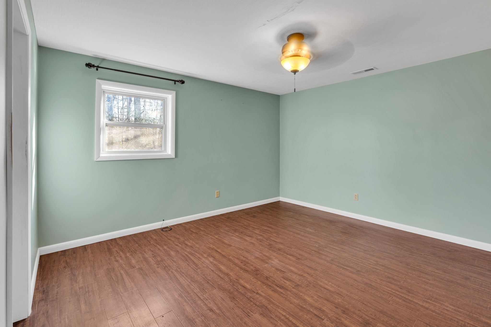 729 Rabbit Trail Road Leoma, TN 38468 - Photo 44 of 52 an empty room with wooden floor and window
