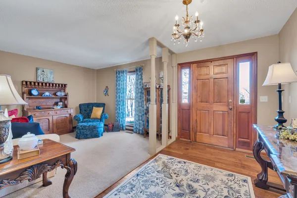 a bedroom with furniture and a chandelier