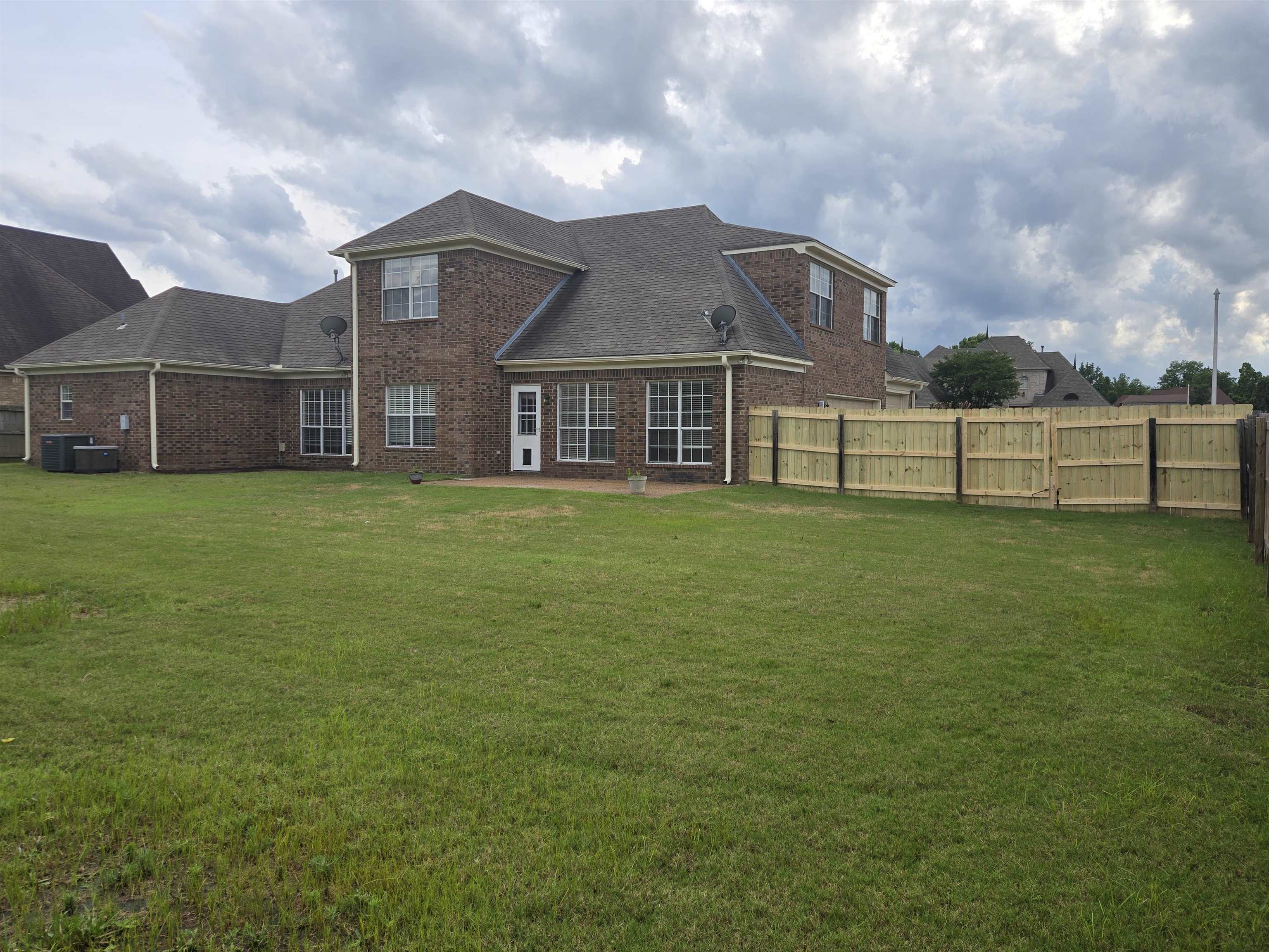 5186 Guffin Road Bartlett, TN 38135 - Photo 2 of 21 a view of a house with a big yard and a large tree