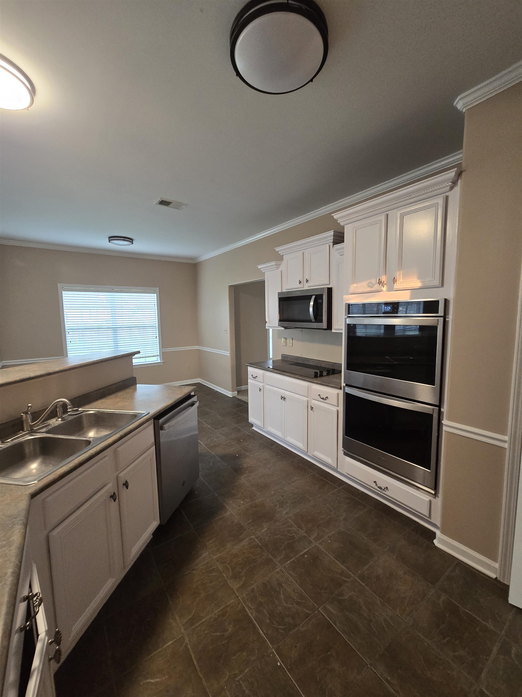 5186 Guffin Road Bartlett, TN 38135 - Photo 5 of 21 a kitchen with stainless steel appliances granite countertop a stove a sink and a refrigerator