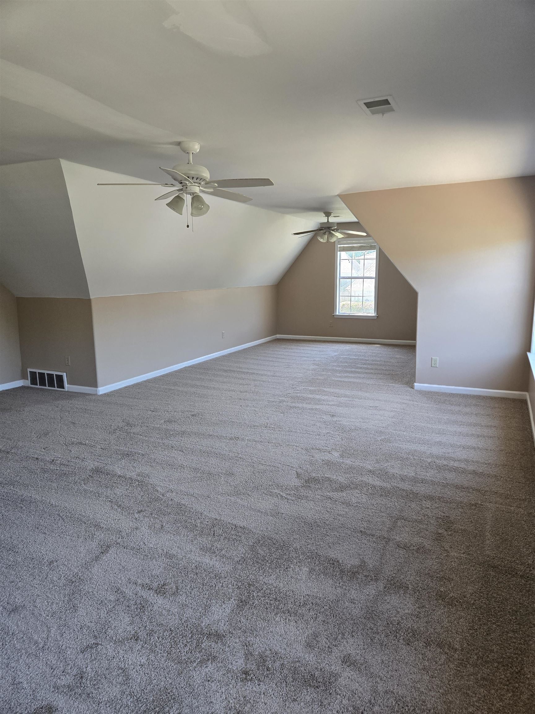 5186 Guffin Road Bartlett, TN 38135 - Photo 9 of 21 a view of empty room with windows and ceiling fan