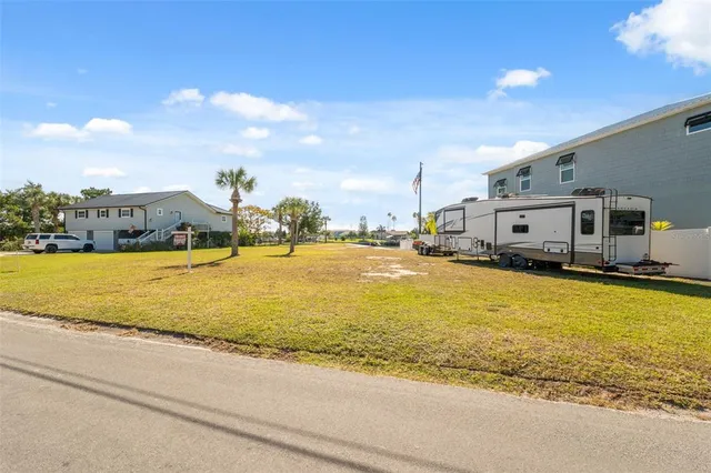 a swimming pool with outdoor seating and yard