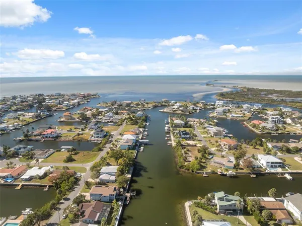 an aerial view of a city with lots of residential buildings and ocean view