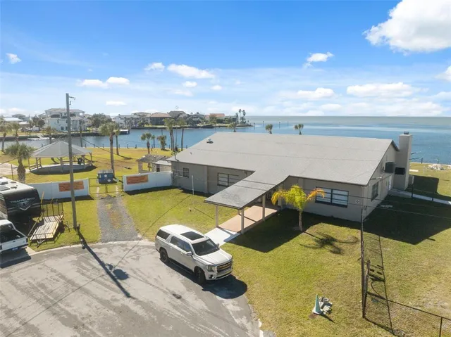 a view of a lake with couches chairs