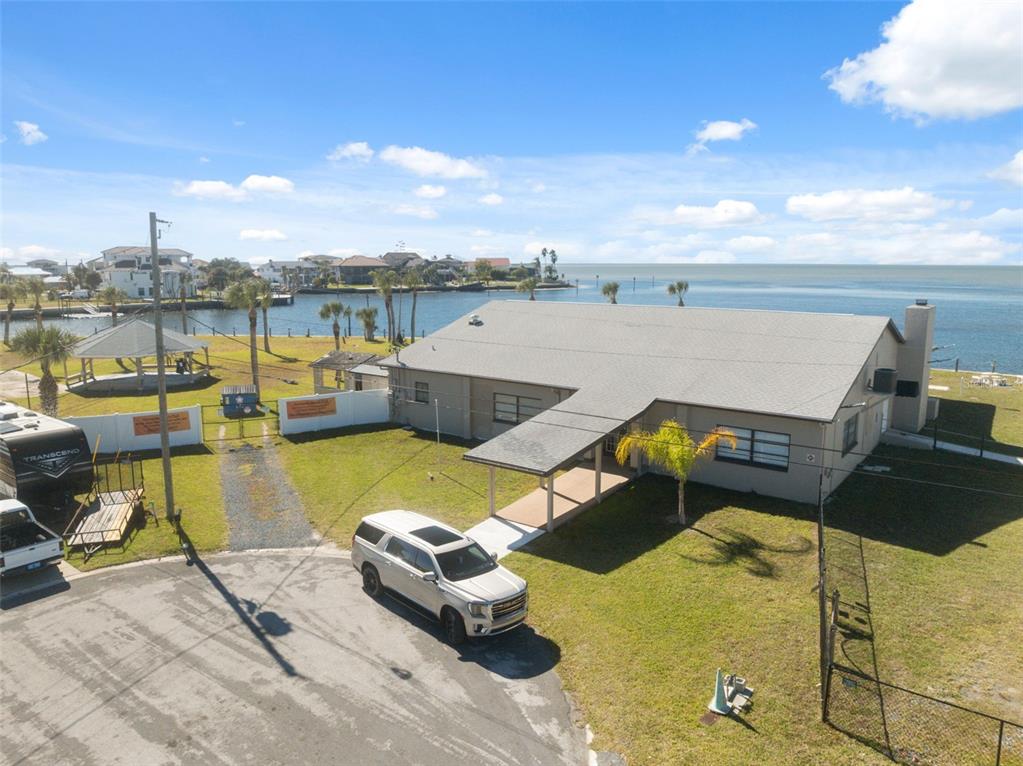 3616 Flamingo Boulevard Spring Hill, FL 34607 - Photo 25 of 35 a view of a lake with couches chairs