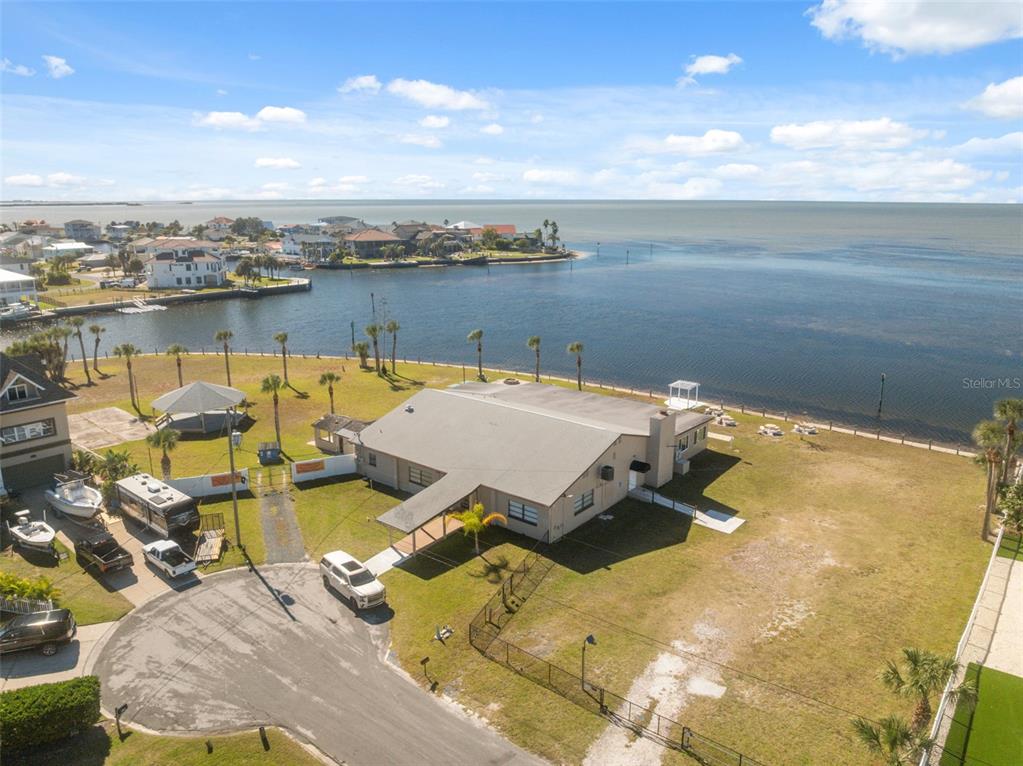 3616 Flamingo Boulevard Spring Hill, FL 34607 - Photo 34 of 35 a view of a lake with a table and chairs