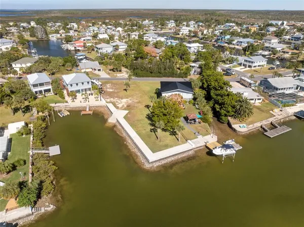 an aerial view of residential houses with outdoor space and ocean view