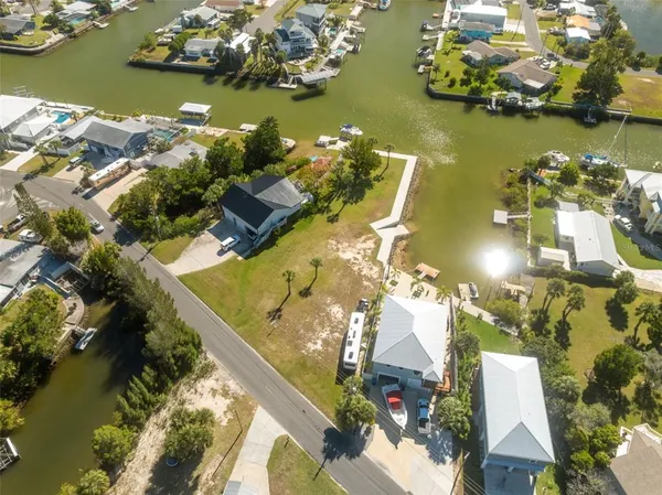 an aerial view of a house with a yard swimming pool and outdoor seating
