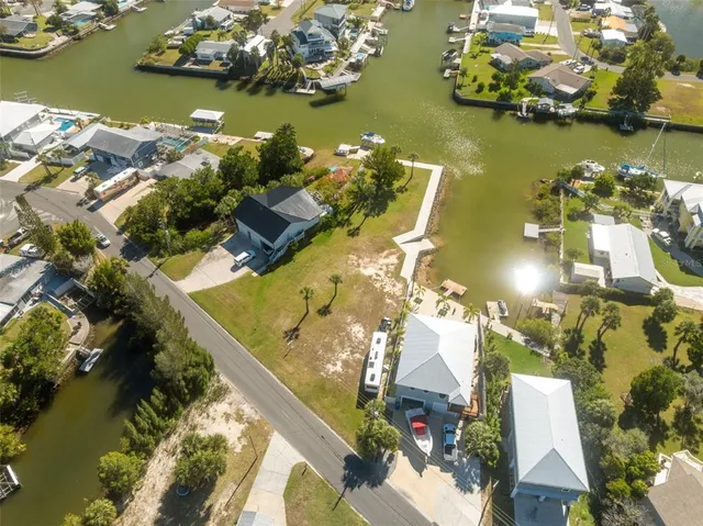 an aerial view of a house with a yard swimming pool and outdoor seating