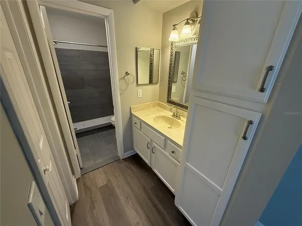 a bathroom with a double vanity sink and a mirror