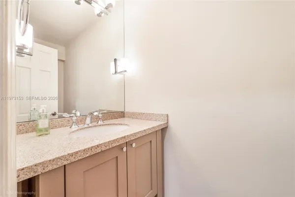 a bathroom with a sink and a mirror