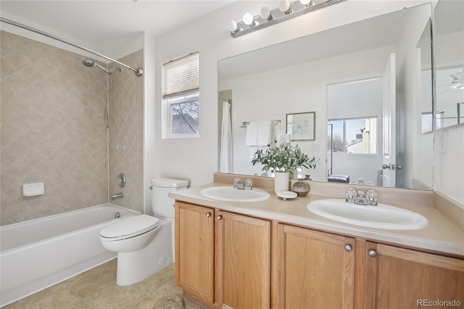 11340 Locust Street Thornton, CO 80233 - Photo 12 of 33 a bathroom with a granite countertop sink a toilet and shower