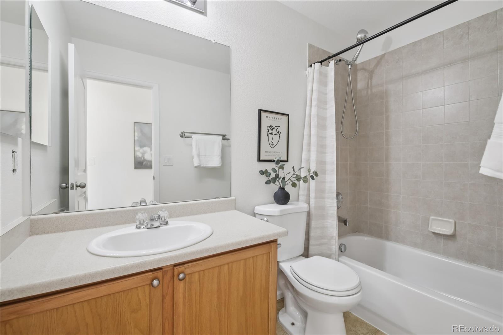 11340 Locust Street Thornton, CO 80233 - Photo 14 of 33 a bathroom with a sink toilet and shower