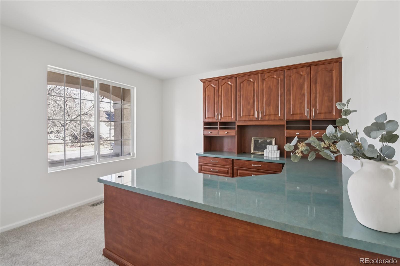 11340 Locust Street Thornton, CO 80233 - Photo 18 of 33 a kitchen with sink a window and cabinets