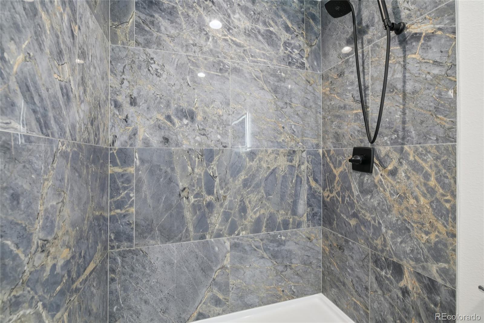 11340 Locust Street Thornton, CO 80233 - Photo 23 of 33 a bathroom with a shower