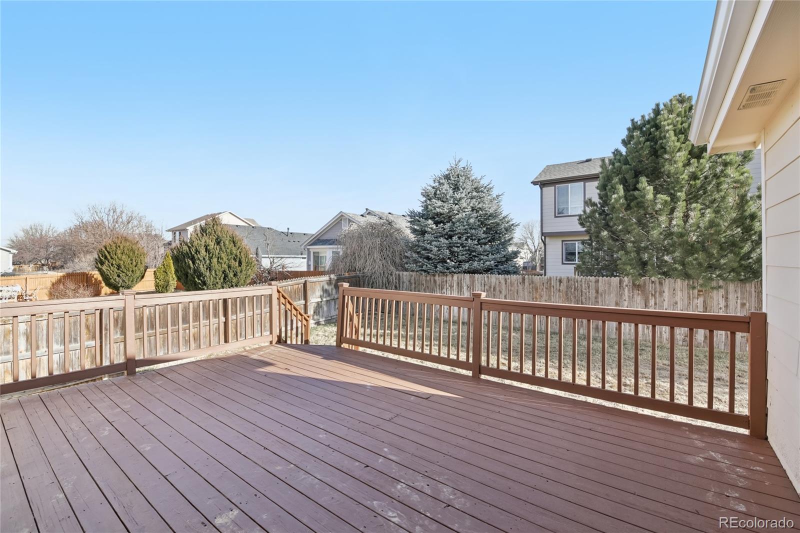 11340 Locust Street Thornton, CO 80233 - Photo 26 of 33 a view of deck with wooden floor and fence
