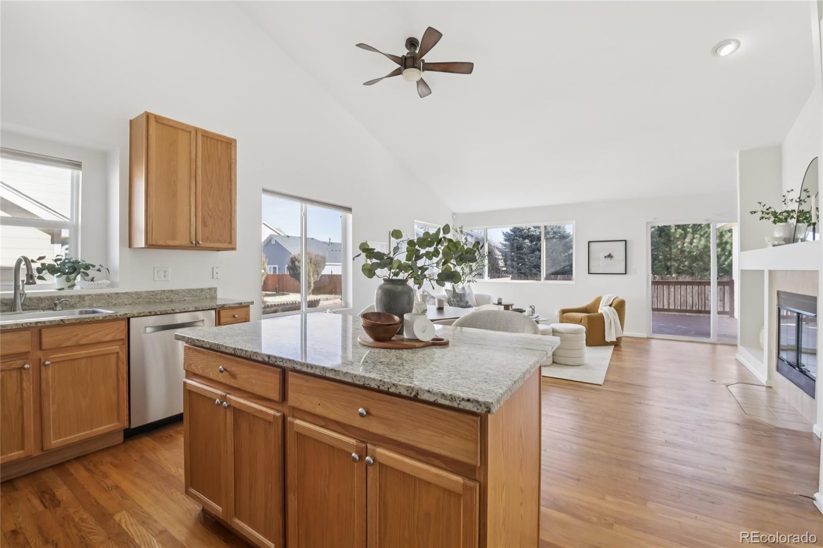 11340 Locust Street Thornton, CO 80233 - Photo 6 of 33 a kitchen with a dining table chairs and white cabinets