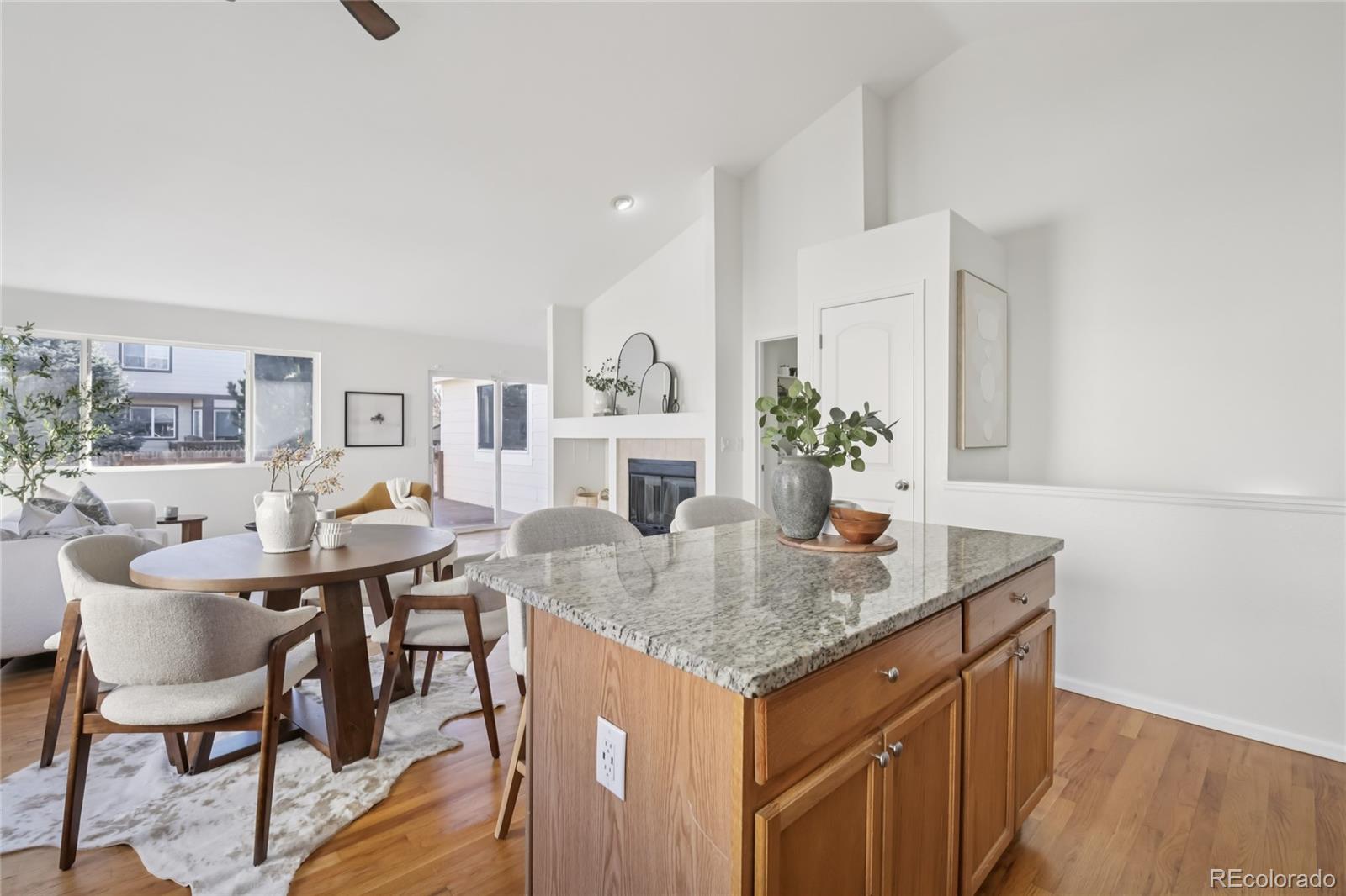11340 Locust Street Thornton, CO 80233 - Photo 7 of 33 a view of a kitchen area with furniture and wooden floor