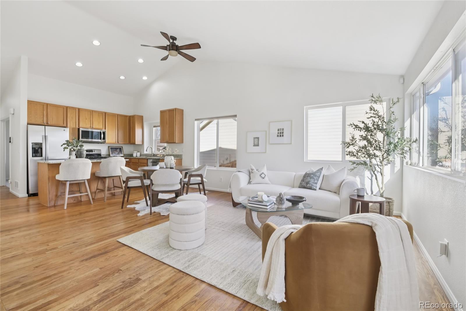 11340 Locust Street Thornton, CO 80233 - Photo 9 of 33 a living room with furniture kitchen view and a chandelier