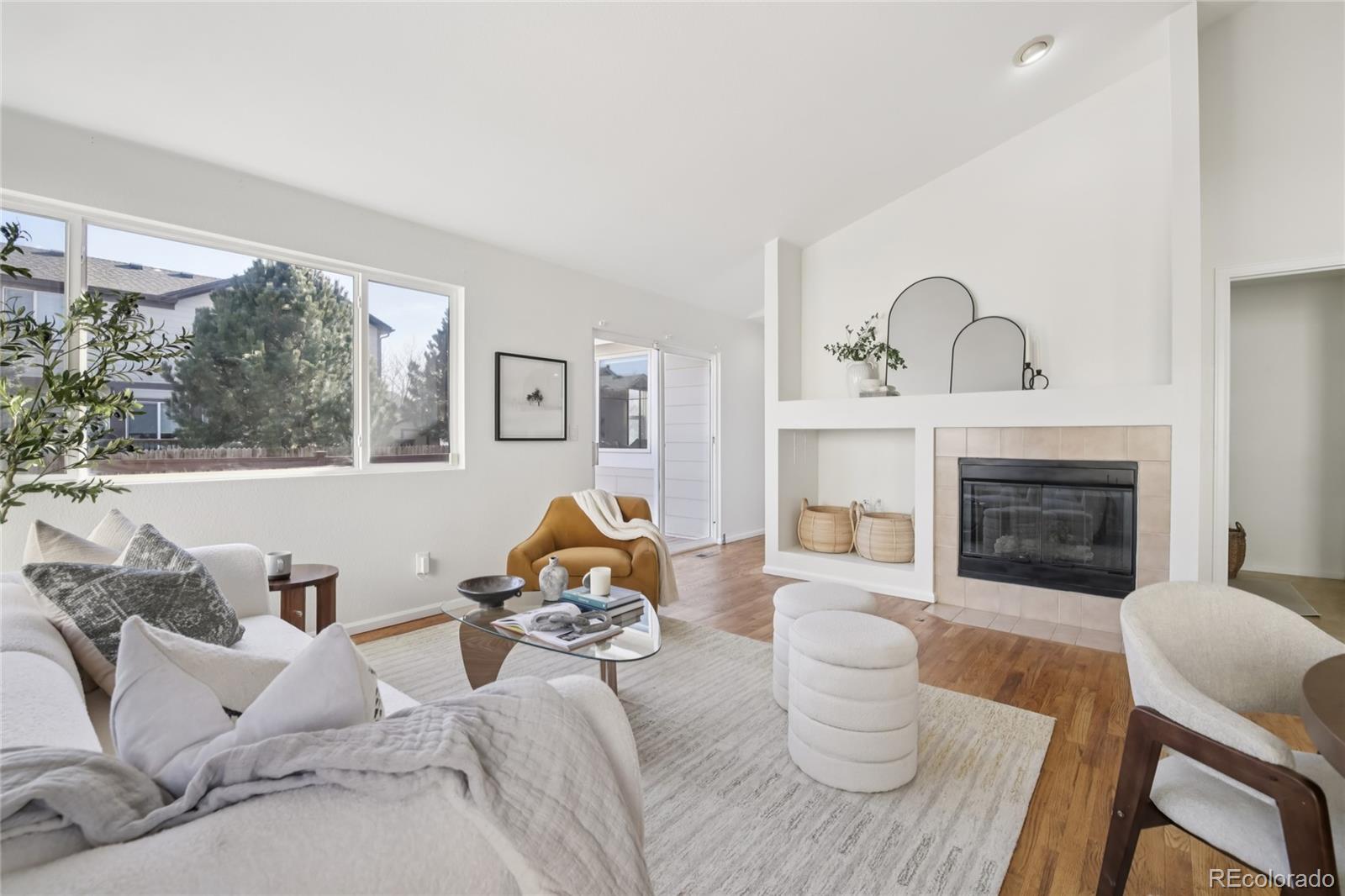 11340 Locust Street Thornton, CO 80233 - Photo 10 of 33 a living room with furniture and a fireplace