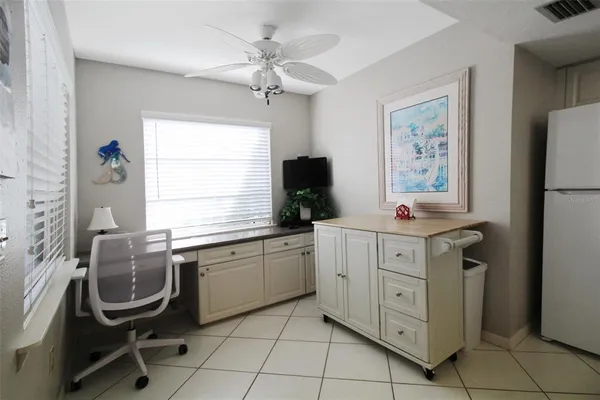 a kitchen with cabinets appliances and furniture