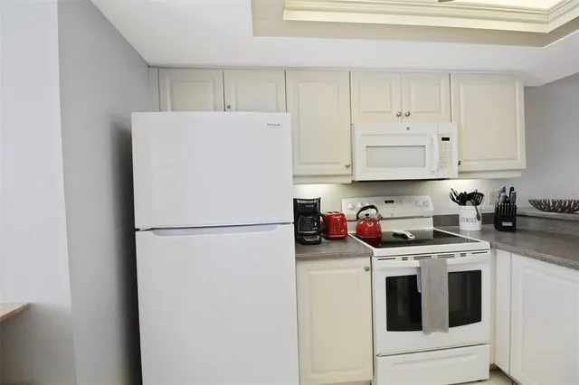 a white refrigerator freezer sitting in a kitchen