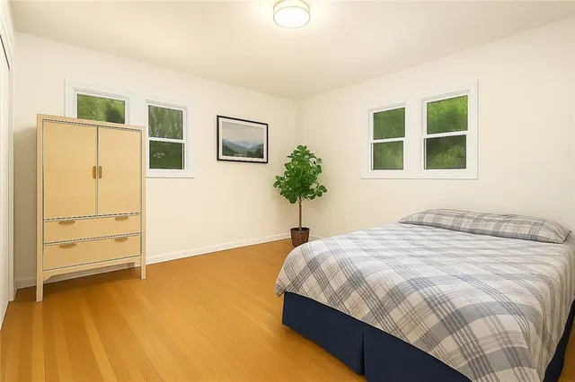 a bedroom with a bed and a potted plant