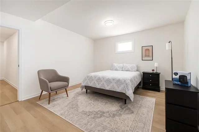 a bedroom with a bed and chair