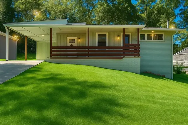 a front view of house with yard and green space