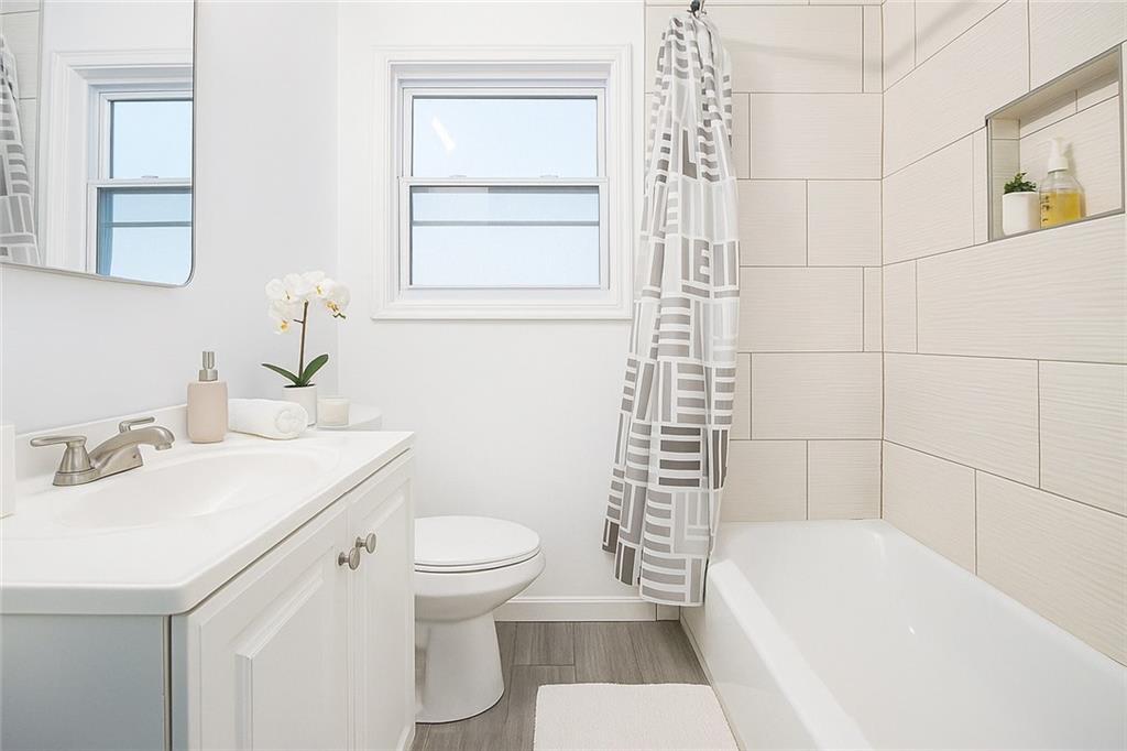 2115 Nichols Lane Decatur, GA 30032 - Photo 9 of 21 a bathroom with a sink a toilet and shower