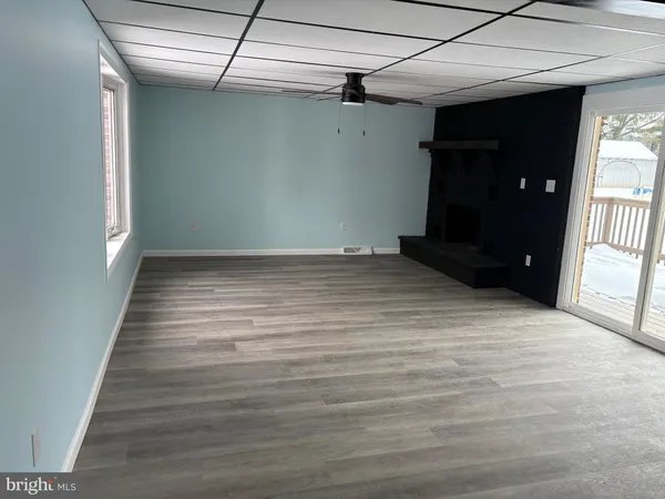 a view of a room with wooden floor