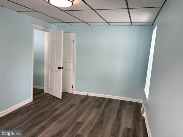 a view of a room with wooden floor