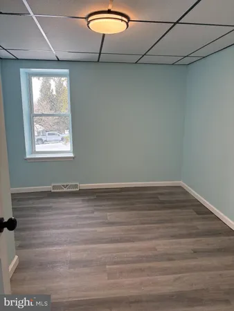 a view of a room with wooden floor and window