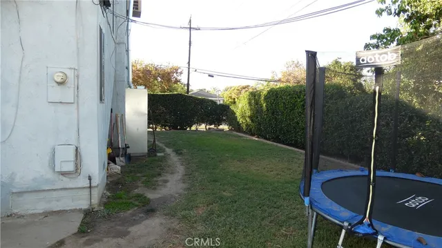 a backyard of a house with a table and chairs