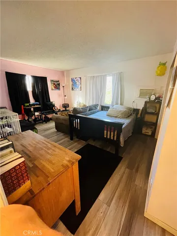 a bed room with a bed and a television