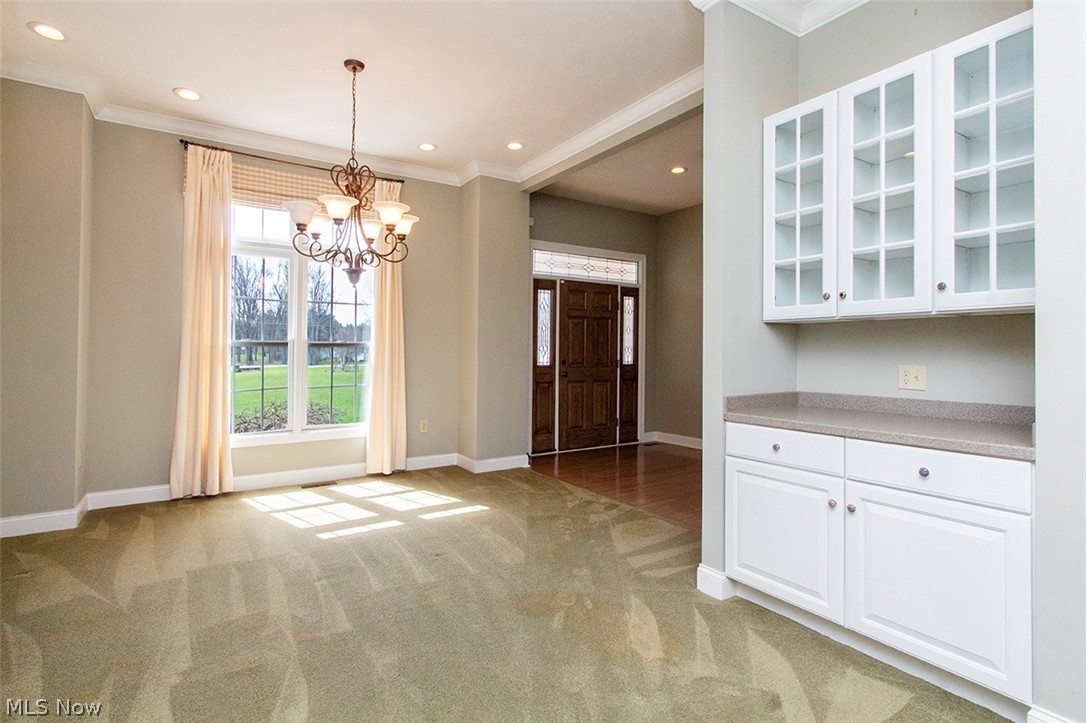 2201 Granger Road Medina, OH 44256 - Photo 7 of 34 Dining room with light colored carpet, suspended lighting, and ornamental molding