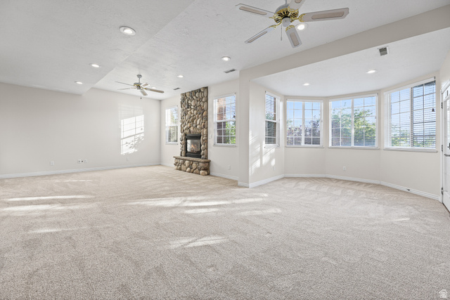 4117 North Wolf Ridge Circle Eden, UT 84310 - Photo 30 of 63 Spacious room featuring a floor-to-ceiling river stone fireplace, bay windows, recessed lighting, and ceiling fans
