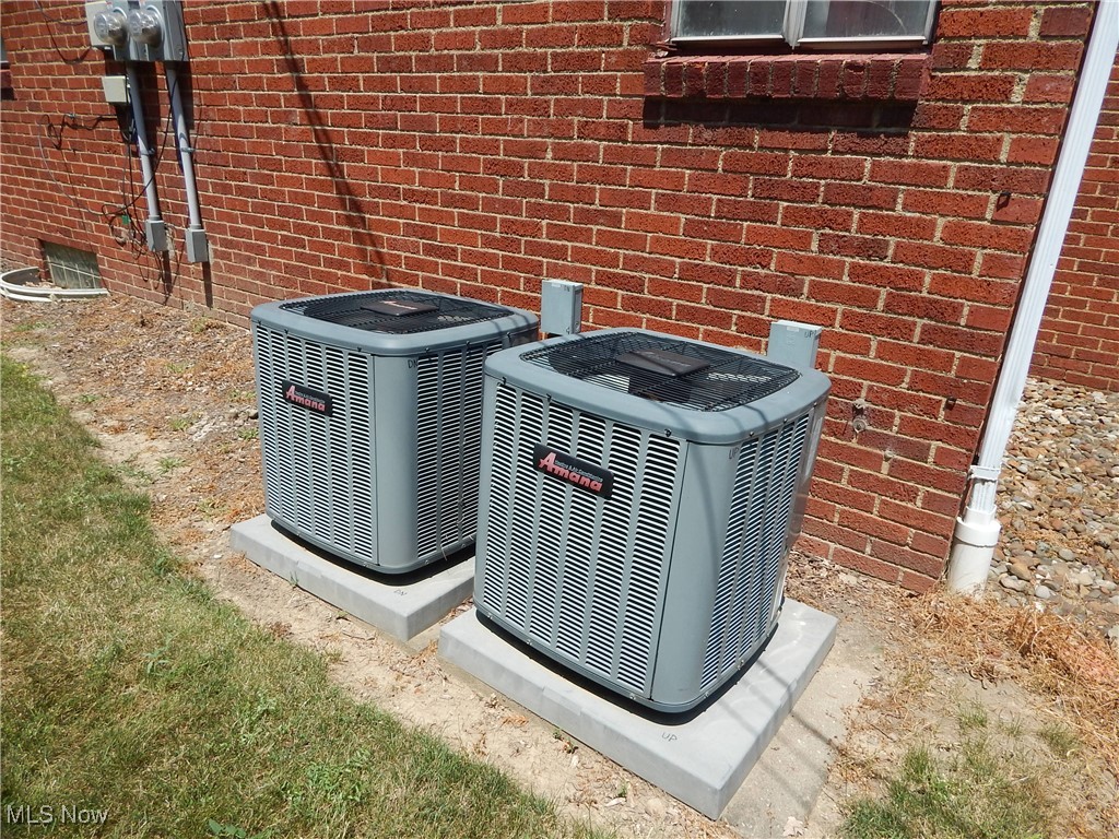 3211 Warren Road Cleveland, OH 44111 - Photo 6 of 32 Exterior view of brick siding and updated central air conditioning units.