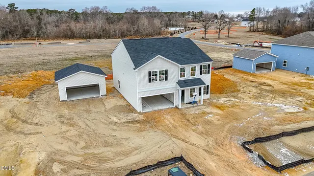 a view of a house with pool and a yard