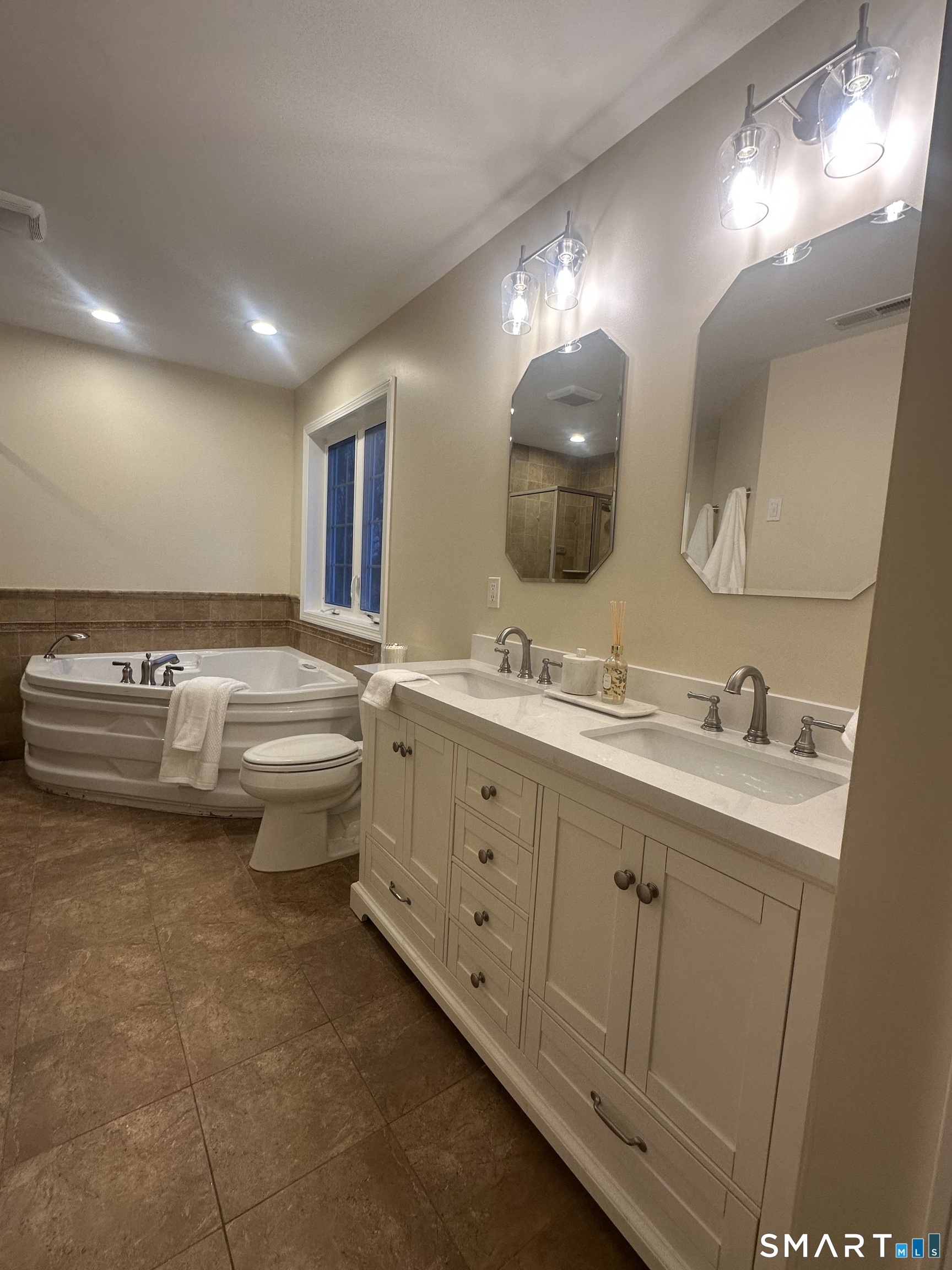 a bathroom with double vanity sink and a mirror