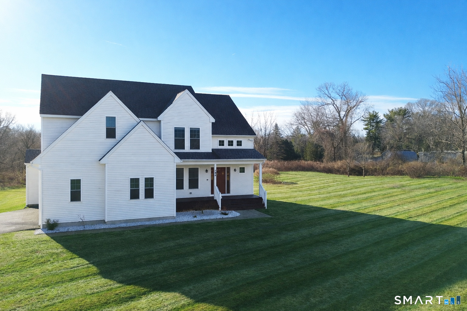 198 Green Hill Road Madison, CT 06443 - Photo 12 of 26 a front view of a house with a yard table and chairs