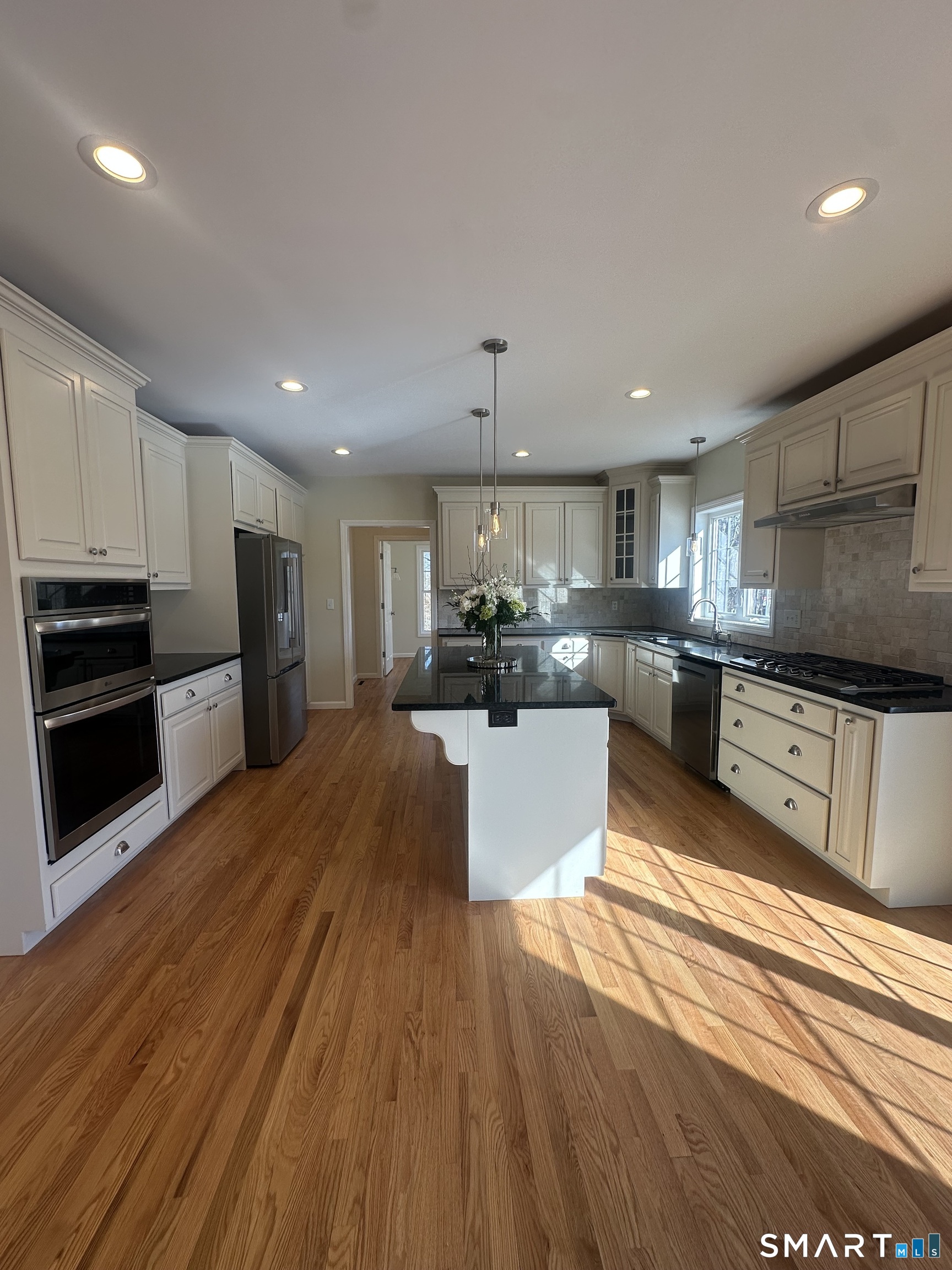 198 Green Hill Road Madison, CT 06443 - Photo 15 of 26 a large kitchen with stainless steel appliances a large counter top a stove and a refrigerator