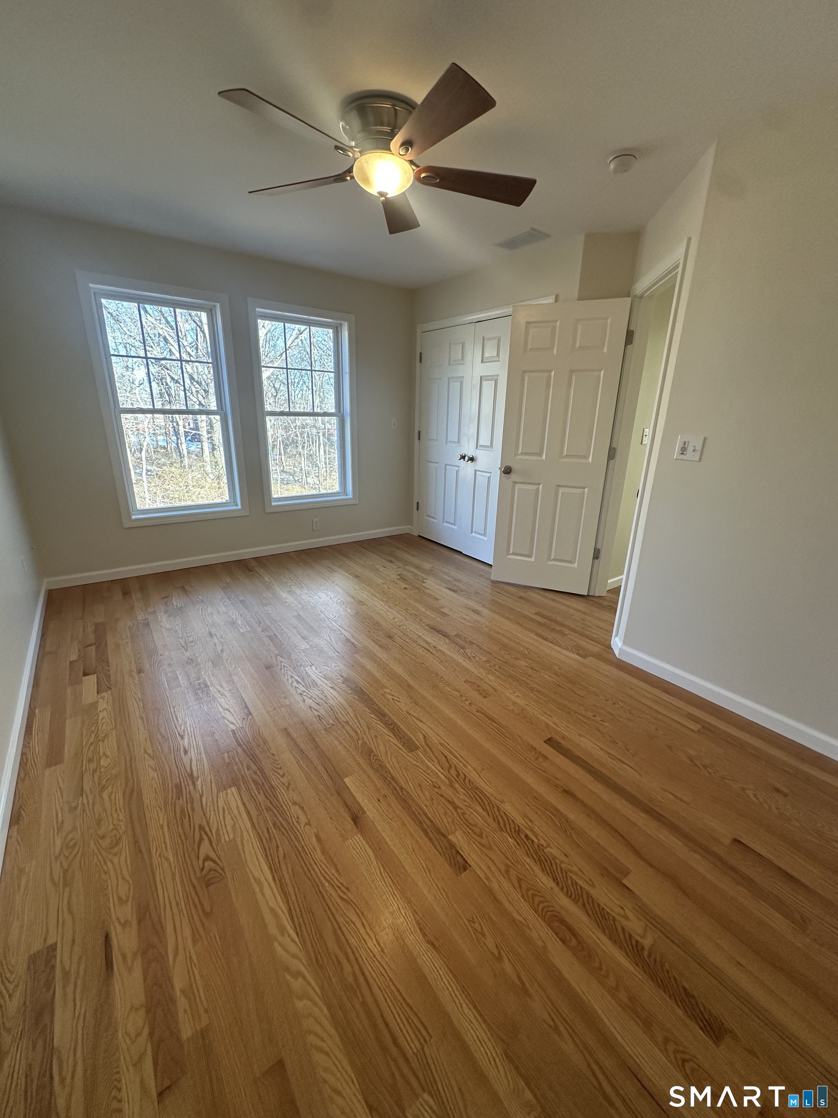 198 Green Hill Road Madison, CT 06443 - Photo 5 of 26 a view of empty room with wooden floor and fan